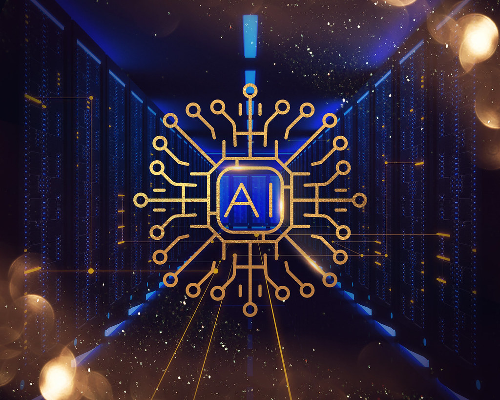 An image of the word "AI" in a circuit board surrounded by golden sparkles and blue microchips.