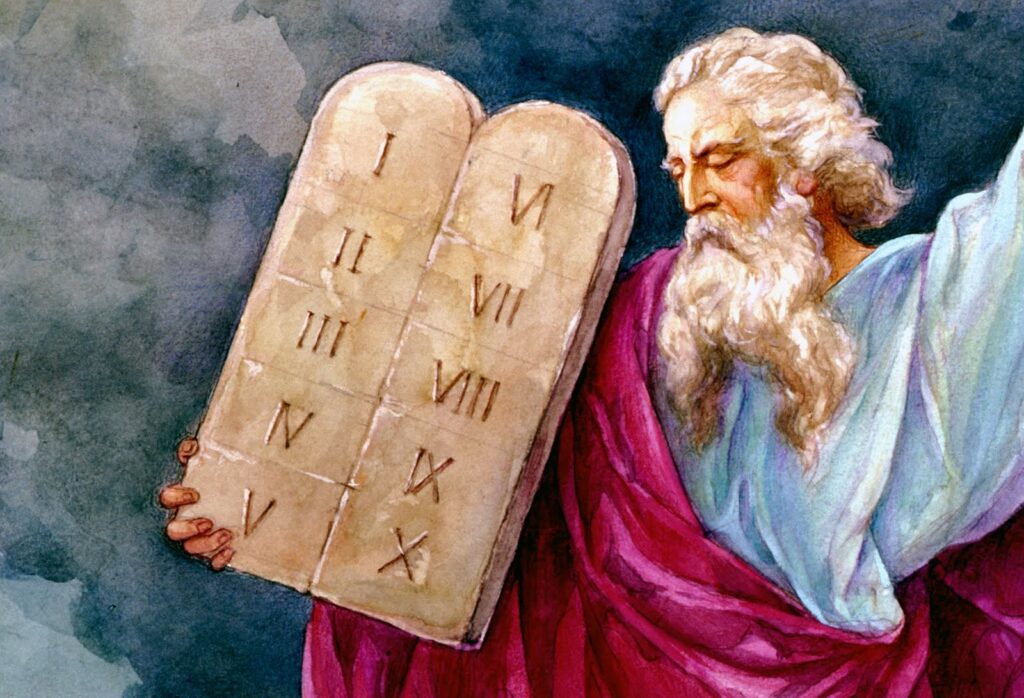 Moses holding the stone tablets depicting the ten commandments.