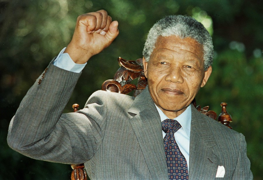 An image of Nelson Mandela, raising his fist in solidarity to the workers and to the people fighting South African apartheid.